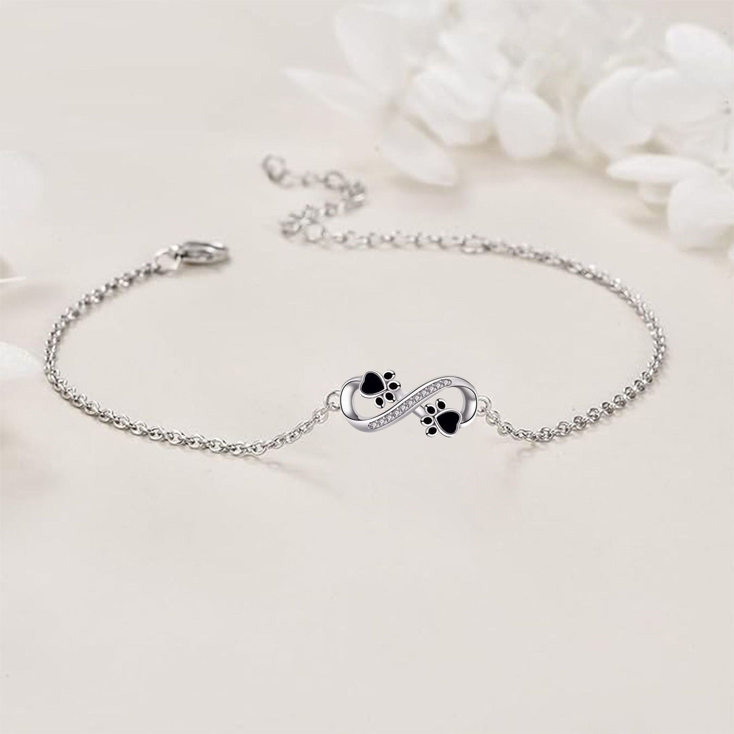 Bracelet avec symbole de l'infini, pendentif avec empreinte de patte et zircons