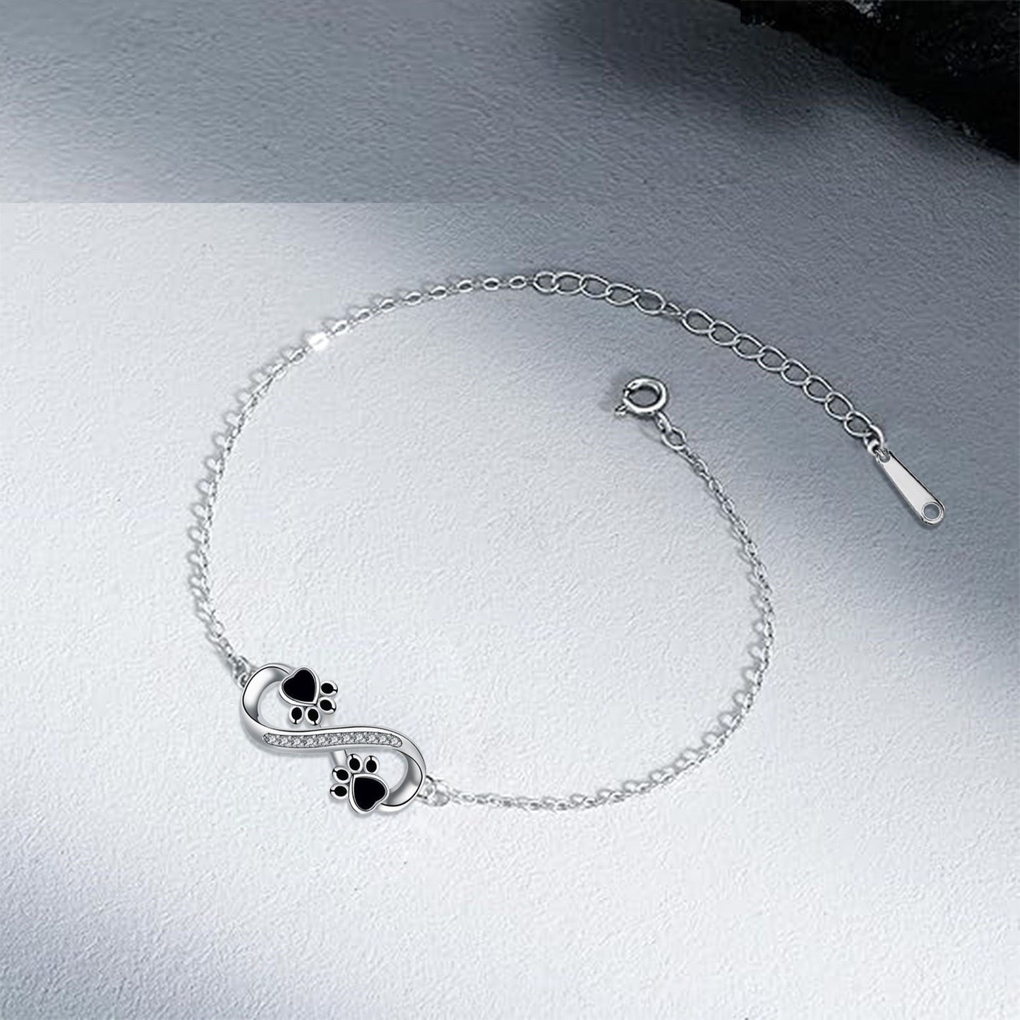 Bracelet avec symbole de l'infini, pendentif avec empreinte de patte et zircons
